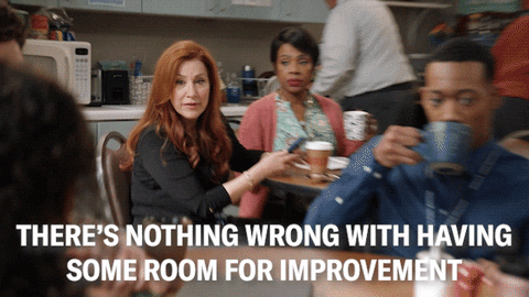 Woman in a staff room saying to a colleague that there is noting wrong with having some room for improvement.